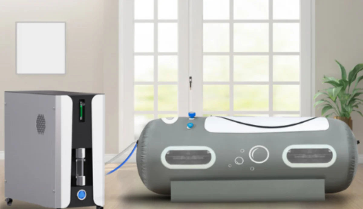 Two gray electronic devices on a light-colored floor with a window in the background