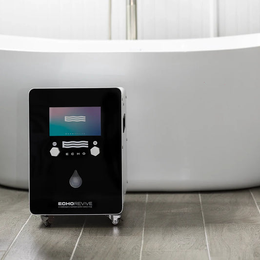 Black hydrogen generator labeled 'Echo Revive' on a tiled floor with a bathtub in the background.