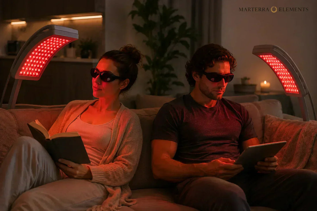 Woman and man sitting on a couch reading while using red light panels