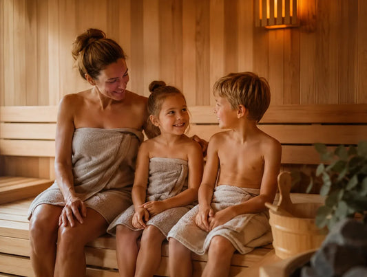 Woman sitting in a sauna with two children