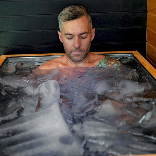 man in a cold plunge full of ice with closed eyes