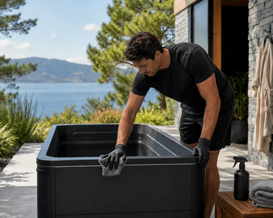 Man cleaning a cold plunge in outdoor setting