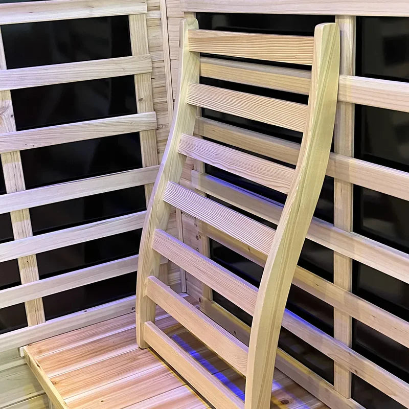 Wooden ladder inside a wooden sauna with black interior