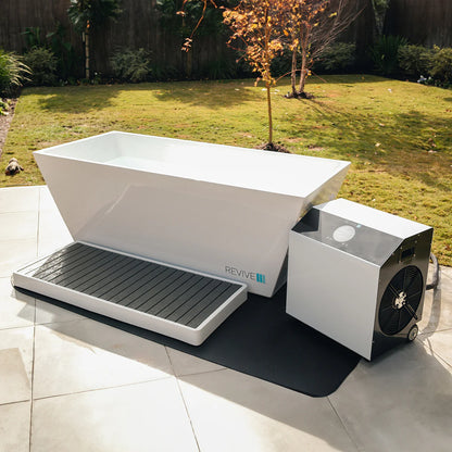 Outdoor dehumidifier with a white container and black base on a tiled patio.