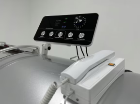 Hyperbaric chamber with a control panel and phone on a white background
