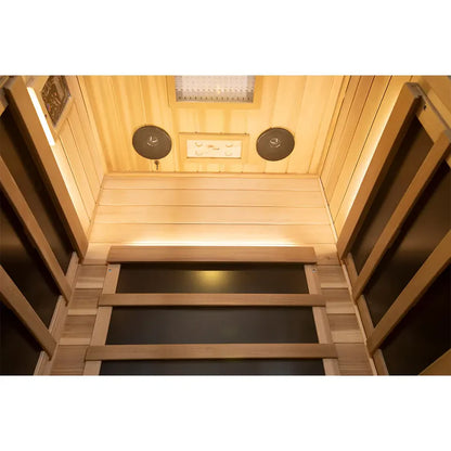 Wooden sauna interior with two speakers on the wall.