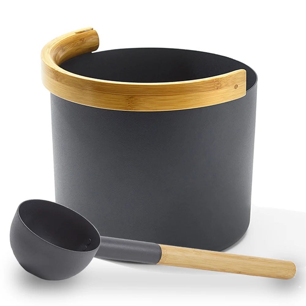 Black bucket with wooden handle and ladle on a white background