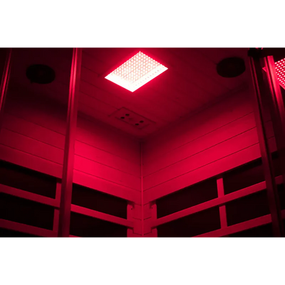 Red-lit indoor setting with a ceiling light fixture.