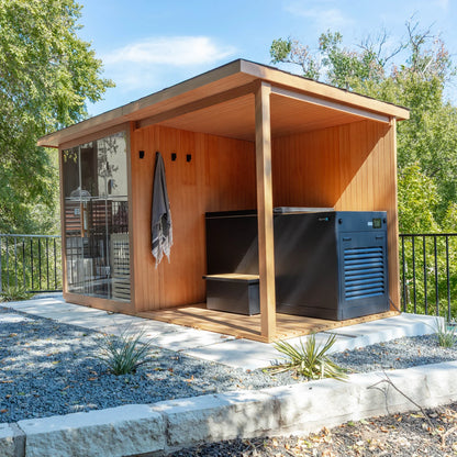 Wooden outdoor shed with a grill and cooler in a garden setting