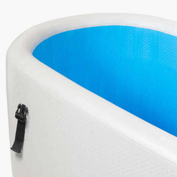 Close-up of a white inflatable pool with blue interior and black zipper.