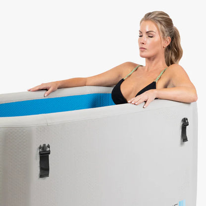 Woman sitting inside a portable hot tub with a white background