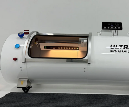 White hyperbaric chamber with 'Ultra Airvida' branding on a gray floor.