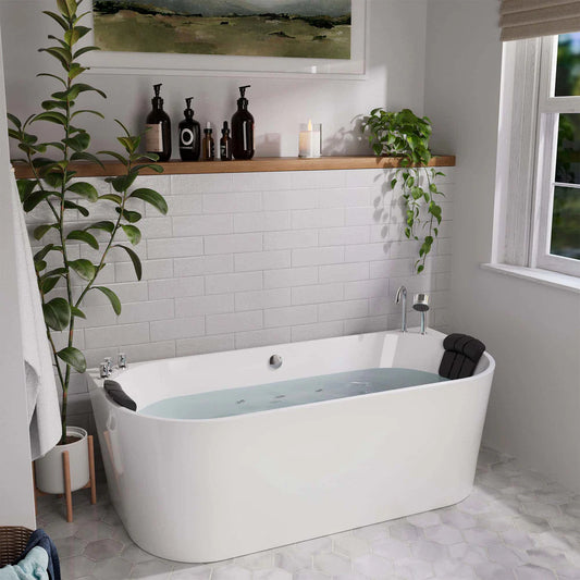Modern bathroom with a freestanding bathtub, plants, and a shelf with bottles.