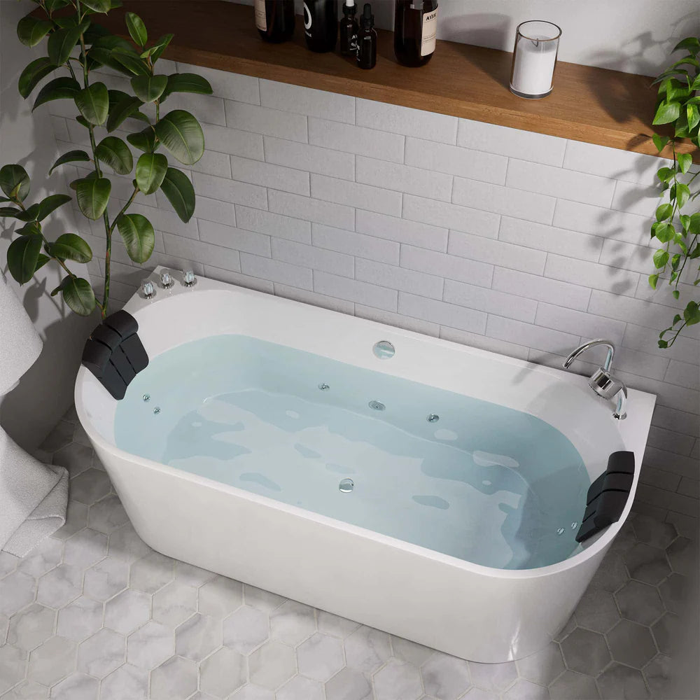 White freestanding bathtub with water in a bathroom setting, featuring a plant and shelves.