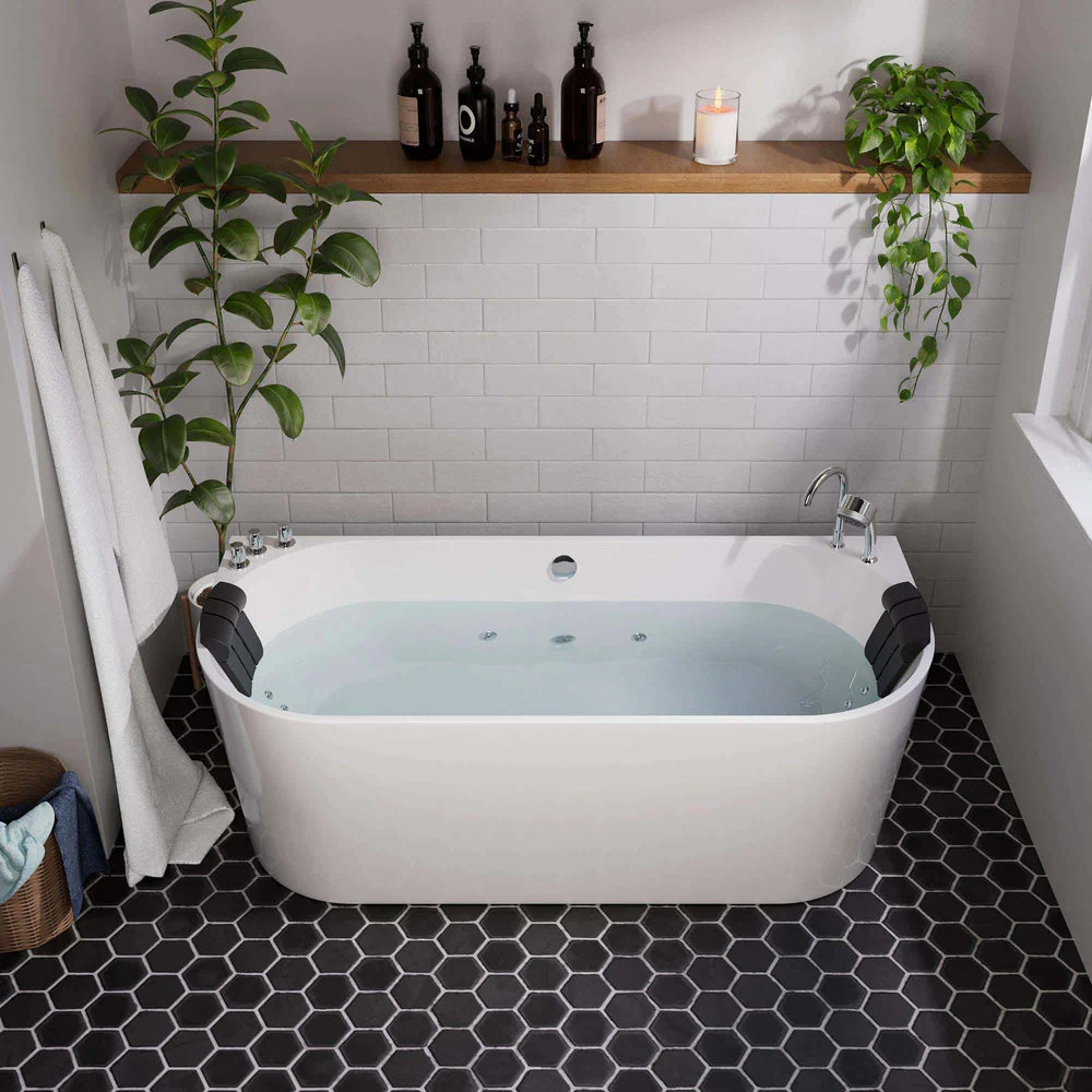 Bathroom with a white bathtub, black tiled floor, and a wooden shelf with bottles and plants.
