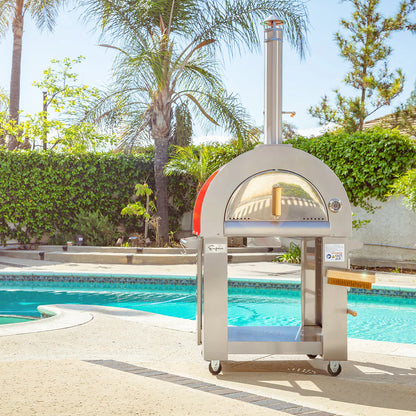 Outdoor pizza oven by a pool with palm trees and greenery in the background