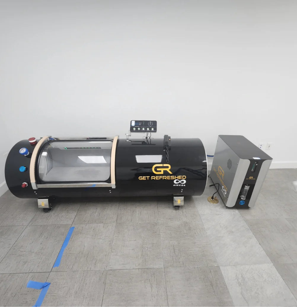 Black hyperbaric chamber with 'Get Refreshed Airvida' branding on a gray floor.