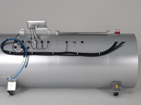 Large cylindrical metal tank with various connections and sensors on a gray background