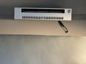Small electronic device mounted on a textured gray wall