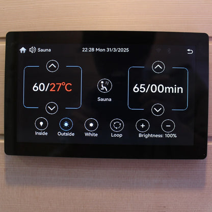 Digital display panel for a sauna with temperature and time settings on a wooden background.