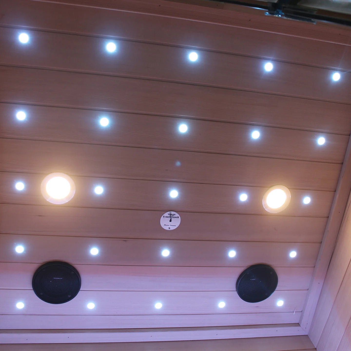 Wooden ceiling with embedded lights and speakers