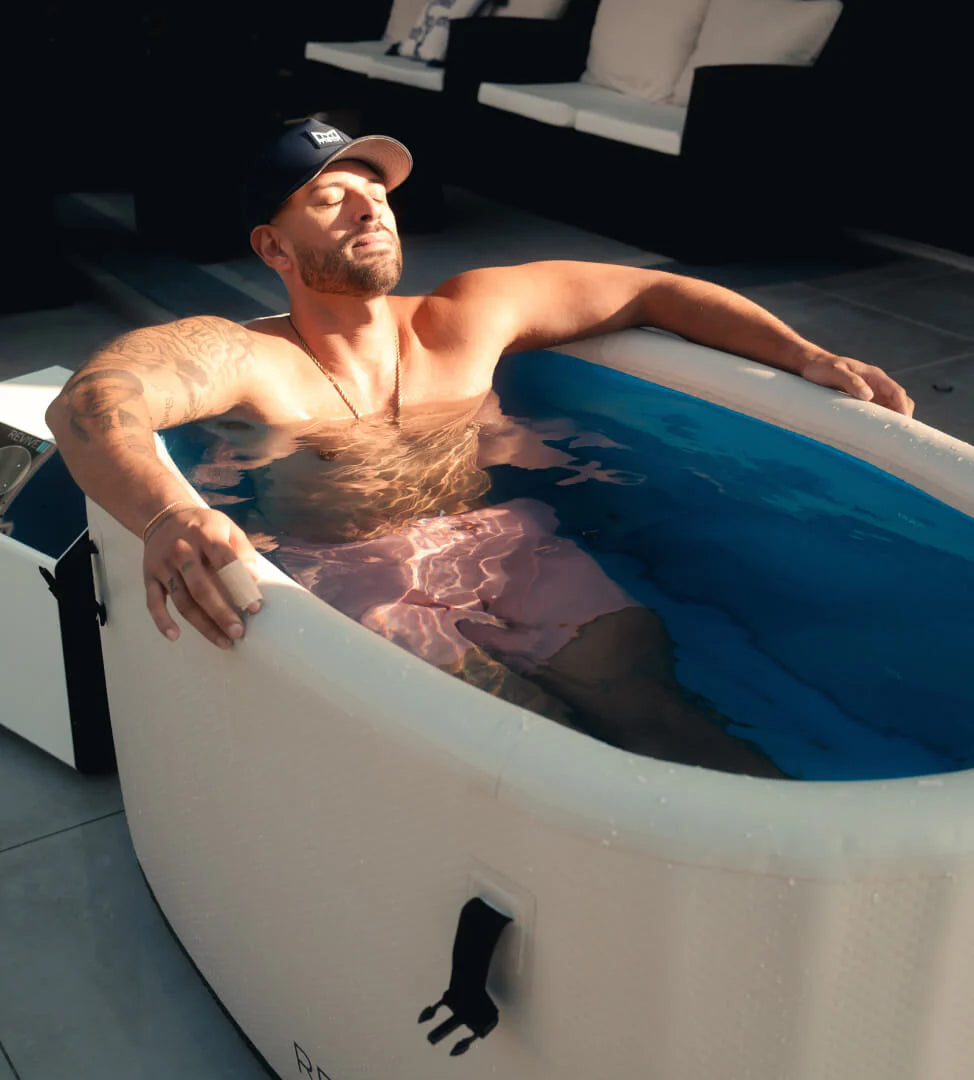 Man relaxing in a portable Cold tub  on a patio