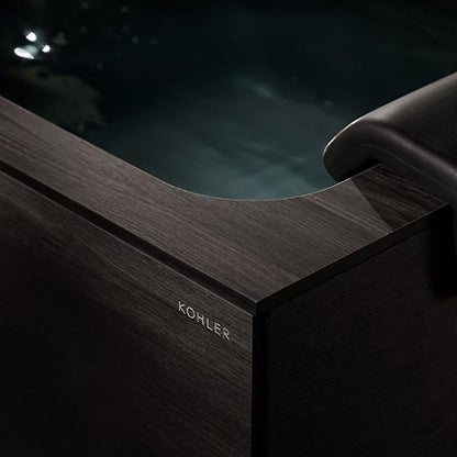 Black bathtub with KOHLER branding 