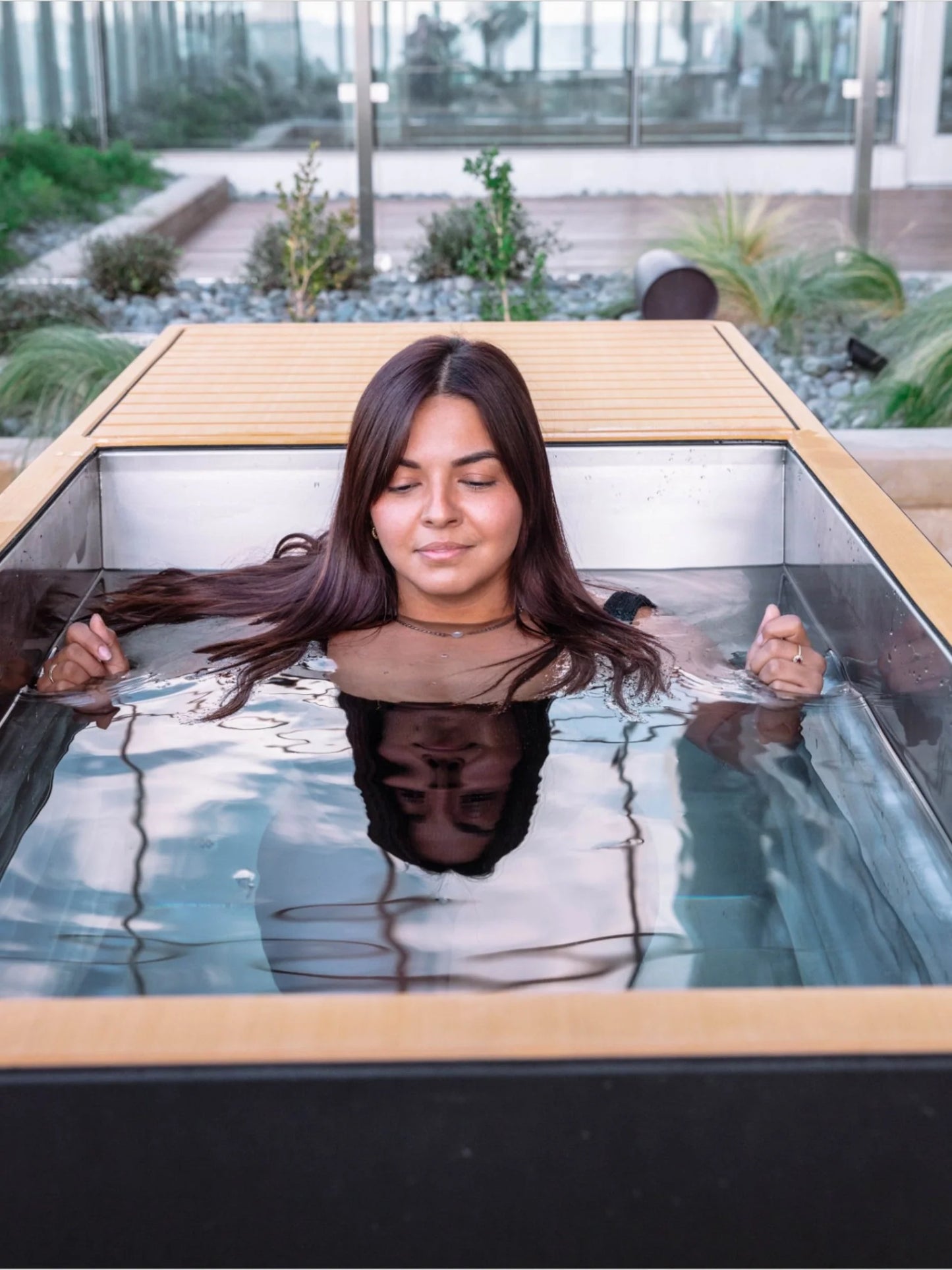 Woman relaxing in a Cold tub with a scenic background