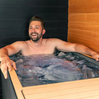 Man relaxing in a Cold tub  with wooden interior
