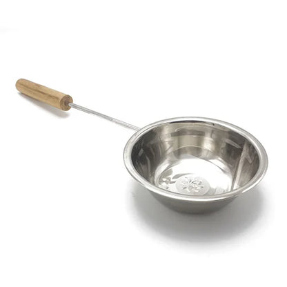 Stainless steel ladle with wooden handle on a white background
