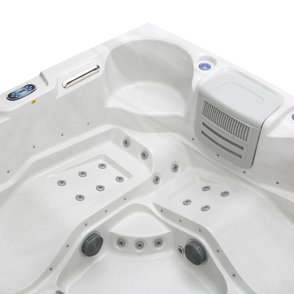 Close-up of a white hot tub with control panel and jets.