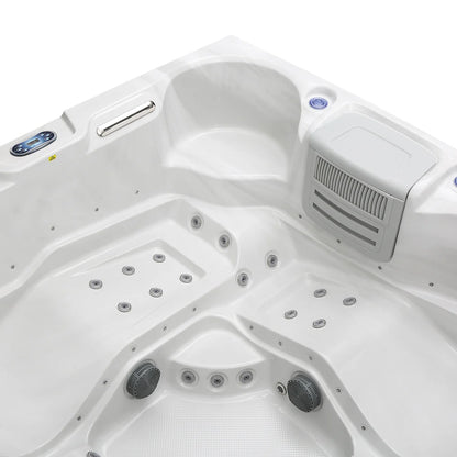 Close-up of a white hot tub with control panel and jets.