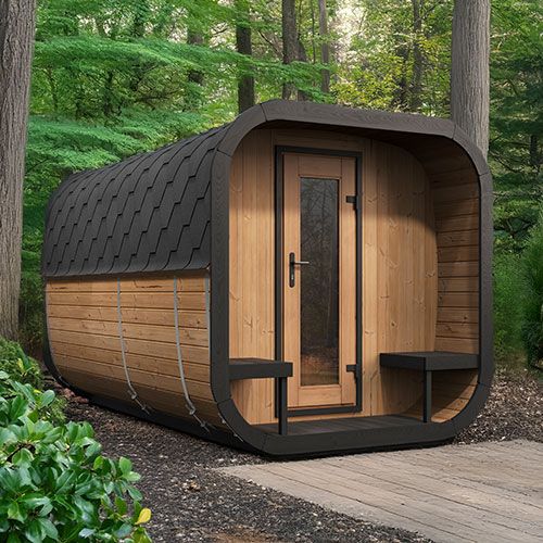 Wooden barrel-shaped cabin in a forest setting