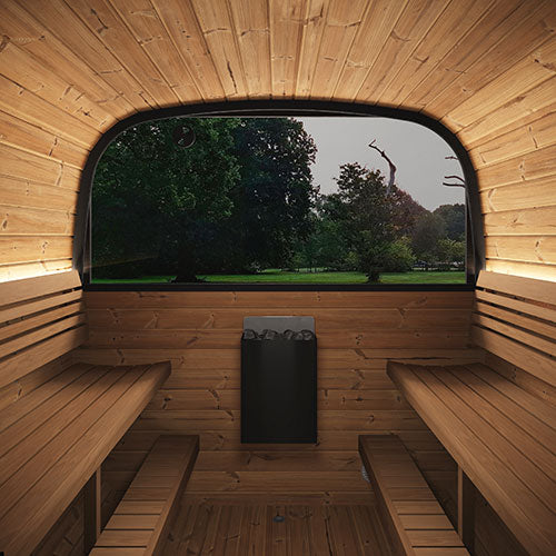 Wooden sauna with benches and a window overlooking a park