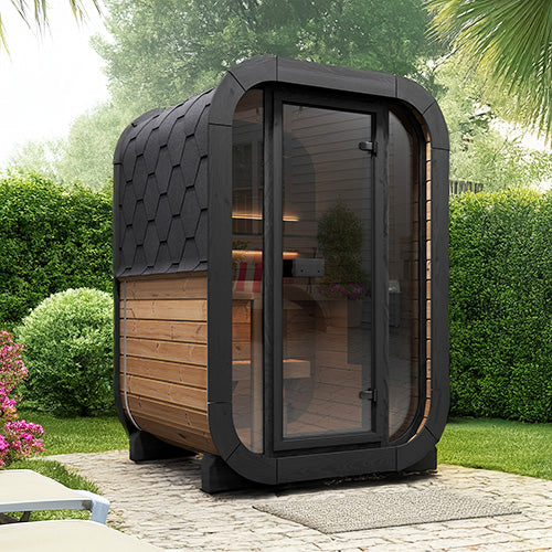 Modern outdoor sauna with wooden interior and black exterior in a garden setting.