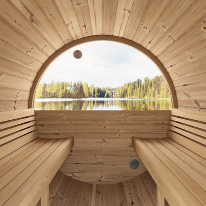 Wooden sauna with a large circular window overlooking a lake and forest.