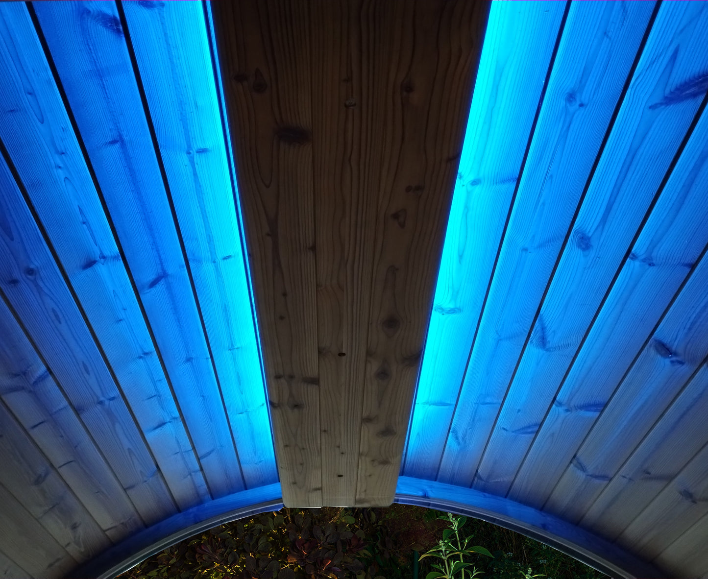 Wooden ceiling with blue LED lights on a circular structure.