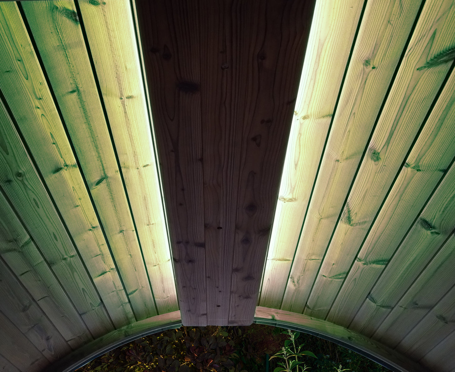 Wooden panel with green paint on a wooden wall