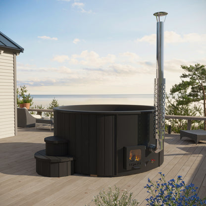 Black outdoor hot tub in a wooden deck with ocean view