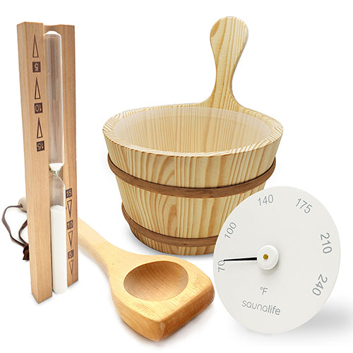 Wooden sauna bucket, ladle, and thermometer on a white background