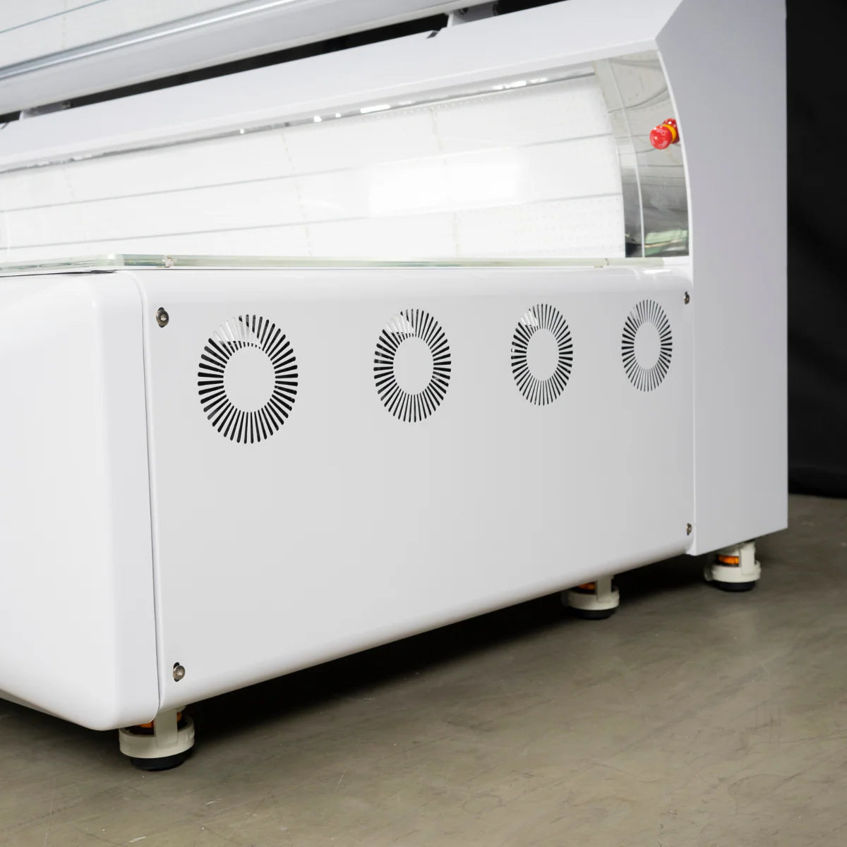 White industrial machine with fans on a gray floor