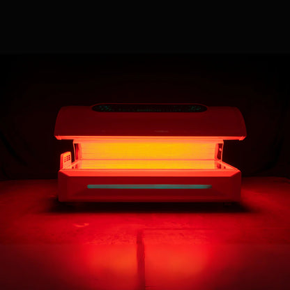 Red light therapy device glowing on a dark background