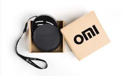 black circular pemf device with a strap on a white background