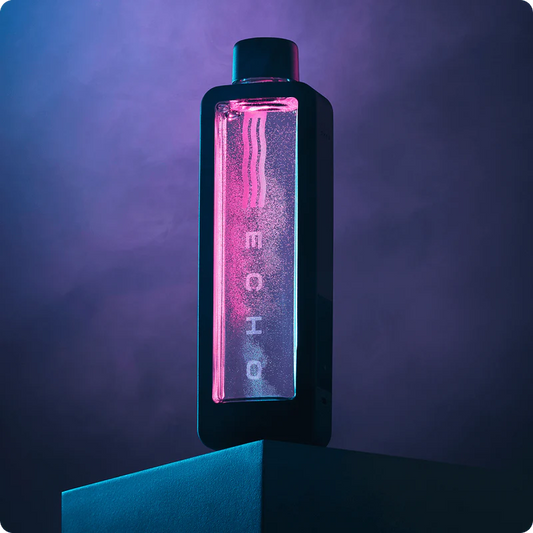 Bottle with a glowing pink interior on a dark background