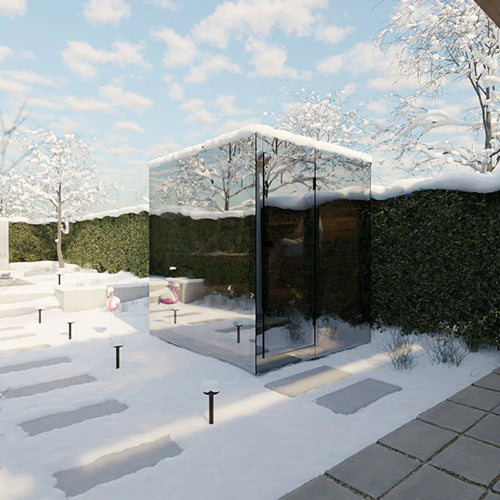 Modern mirrored cabin in a snowy landscape with trees and a clear sky.