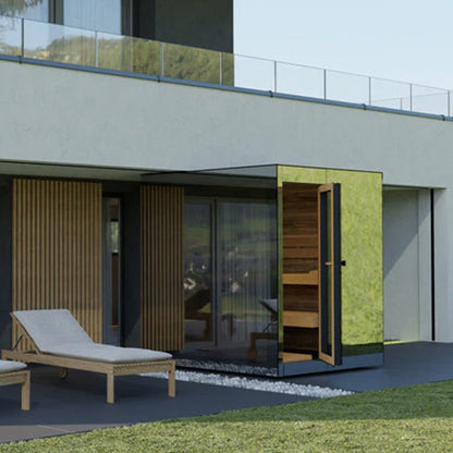 Modern outdoor area with a lounge chair and a reflective glass sauna in front of a building.