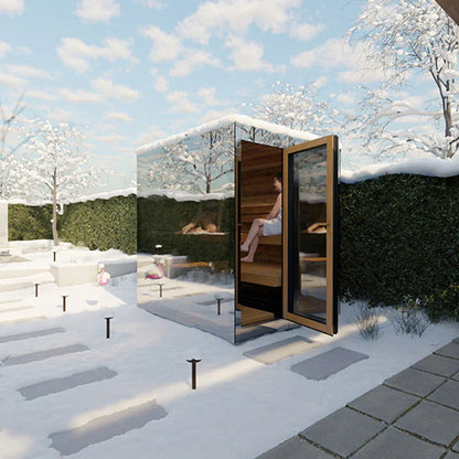 Modern outdoor sauna with mirrored walls in a snowy garden setting