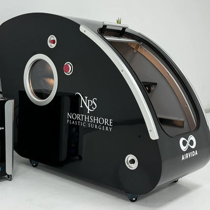 Hyperbaric Chamber with 'Northshore Plastic Surgery' and 'Airvida' logos on a white background