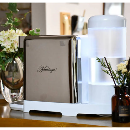 water machine with 'Mariage' on a shelf with flowers and a bottle in the background