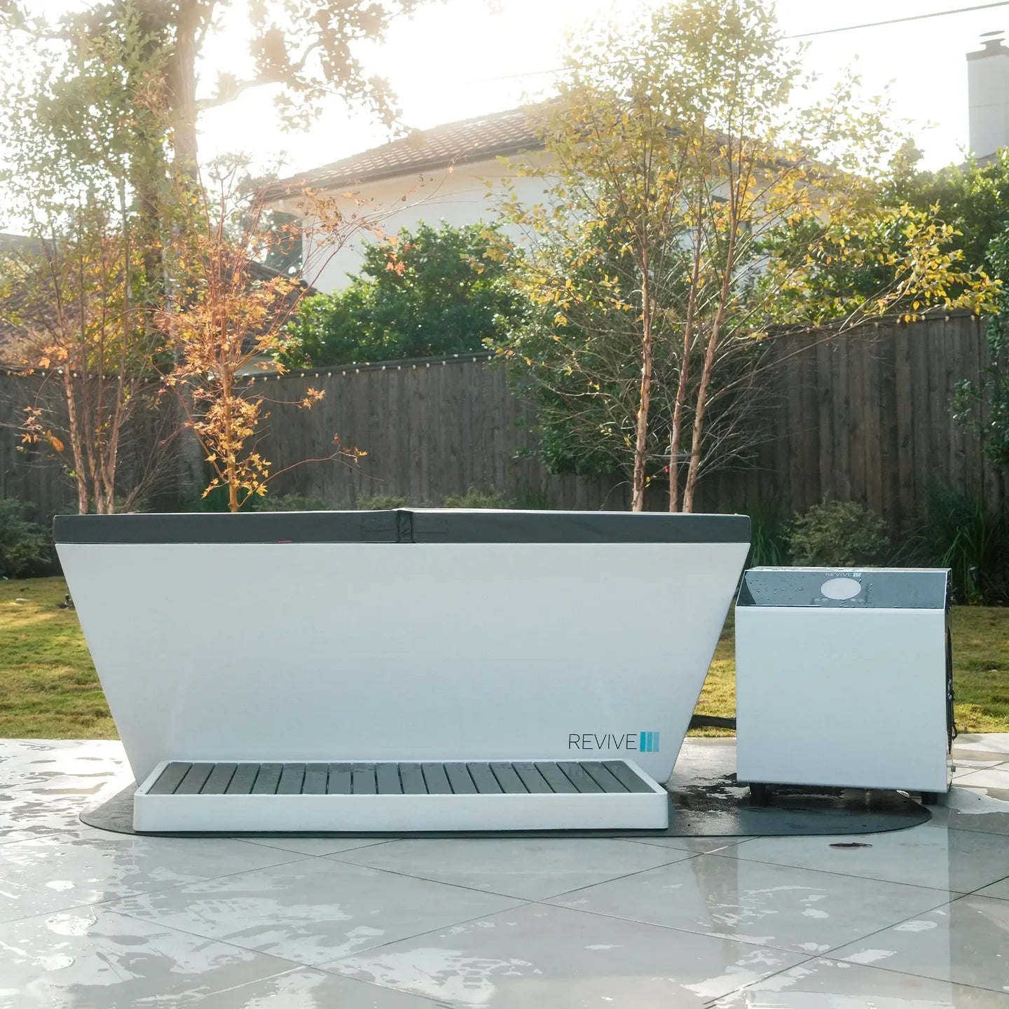 Outdoor setting with a large white and gray planter and smaller matching container on a tiled patio.